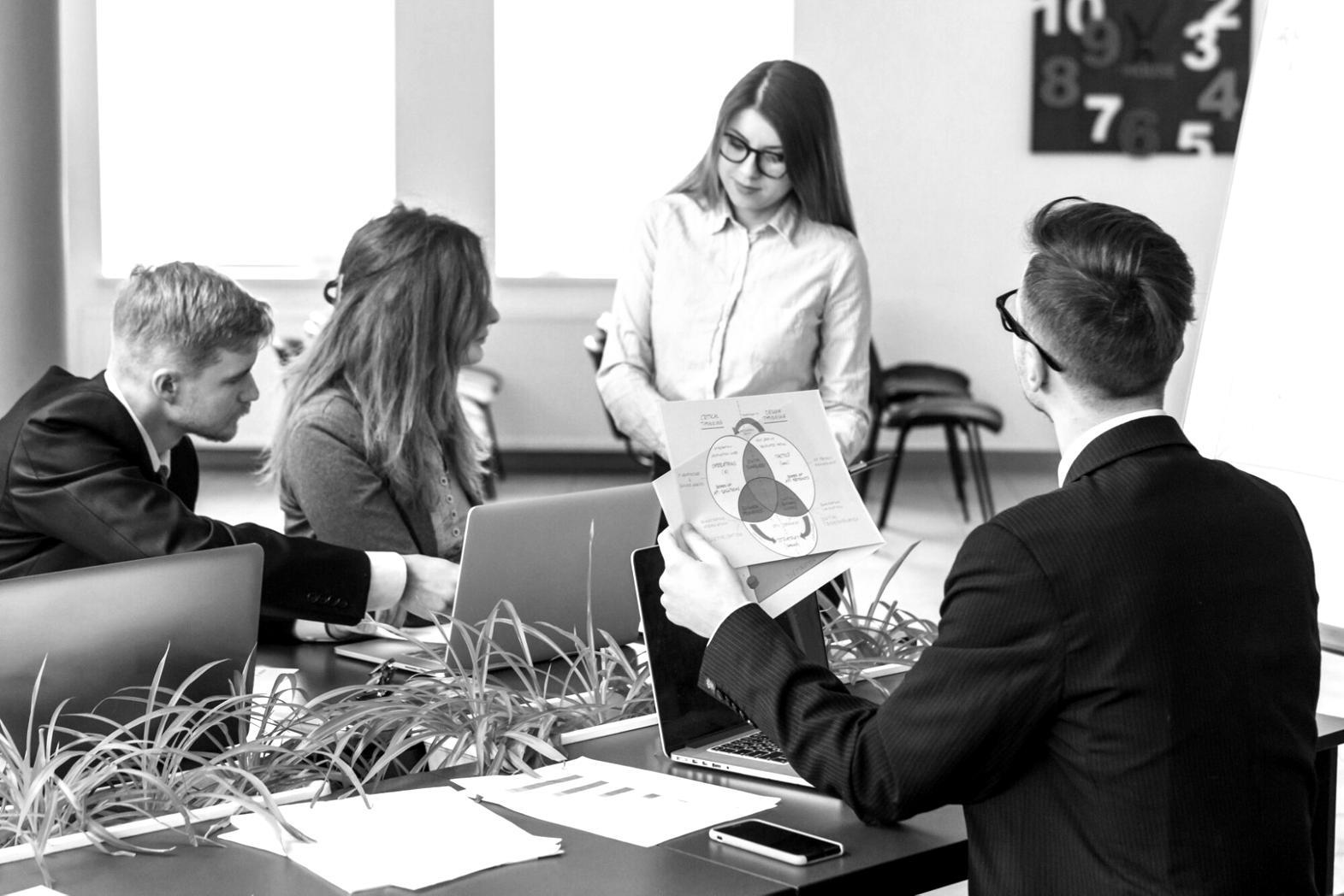 Strategic consultation session with technology team reviewing testing methodologies